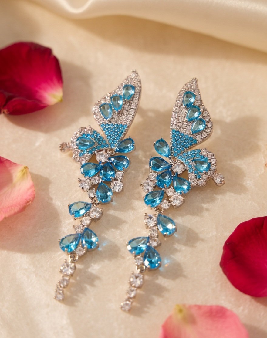 Vivid Blue Topaz And Crystal Wing Zirconia Earrings-Platinum Finish