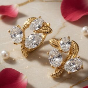 The Elara Oval Cluster Leaf Huggies Hoops-Gold Finish